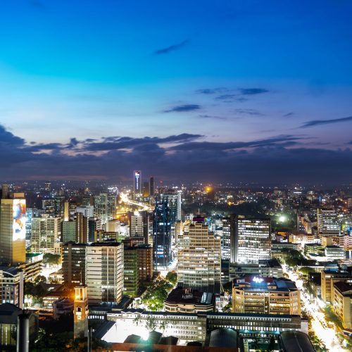 Breathtaking view of Nairobi's skyline during twilight, showcasing vibrant city lights.