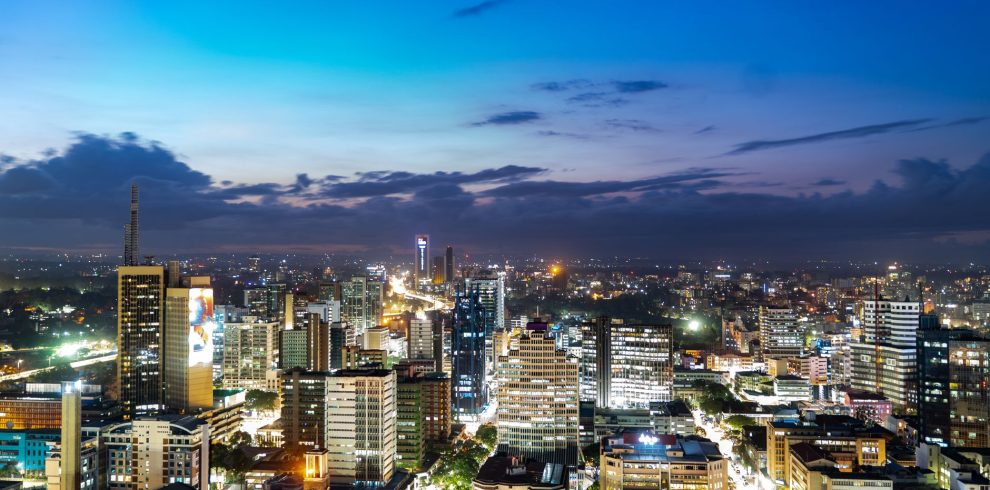 Breathtaking view of Nairobi's skyline during twilight, showcasing vibrant city lights.