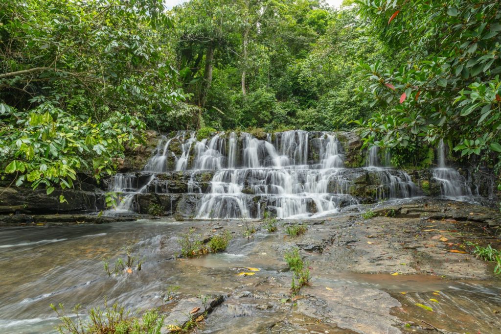 Beautiful cascading waterfall surrounded by lush green rainforest in Costa Rica.