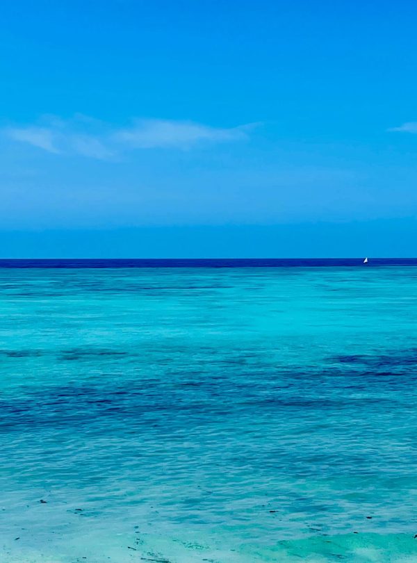 Karibu Kenya Safaris - Explore the breathtaking turquoise waters of Zanzibar's serene beach, ideal for tropical escapes.