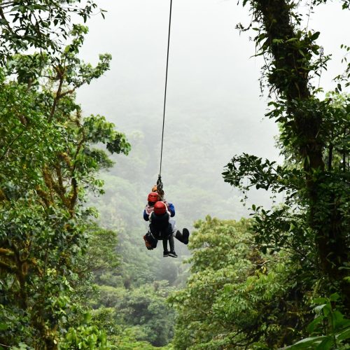 Experience an exhilarating zip line ride through the lush Costa Rican rainforest, ideal for adventure seekers.